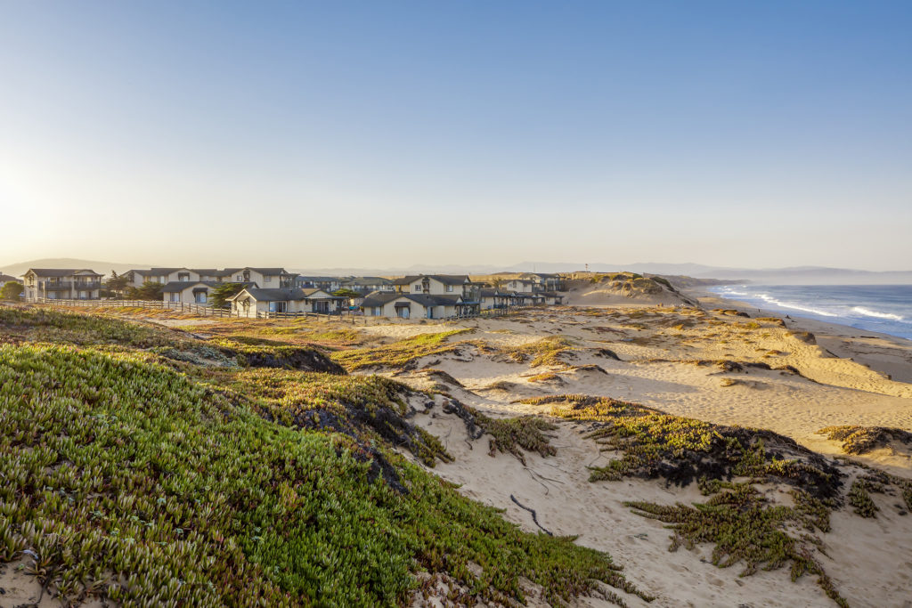 View of The Sanctuary Beach Resort in Monterey, CA from the surrounding sand dunes