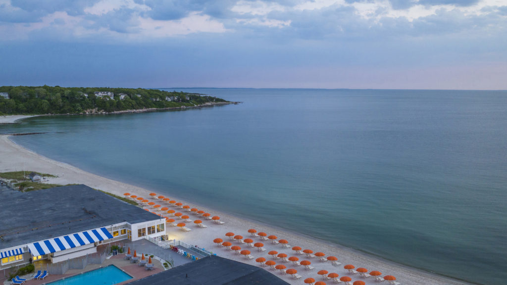 Aerial drone shot of the ocean and Sea Crest Beach Hotel in Cape Cod