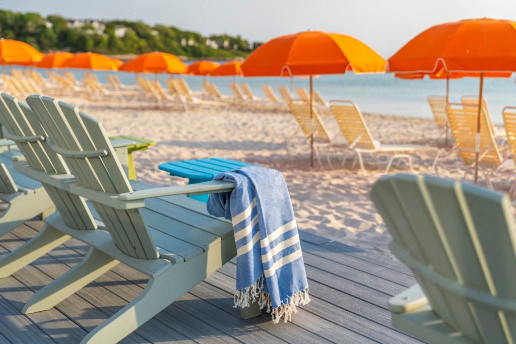 Close up of lounge chairs on a deck along the beach at Sea Crest Beach Hotel in Cape Cod
