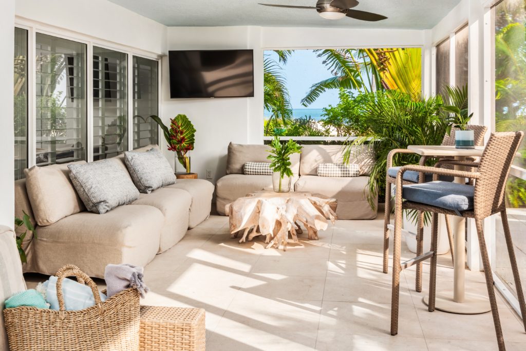 Curry Suite Ocean View at Islander Resort. Living room in screened in patio with an ocean view.