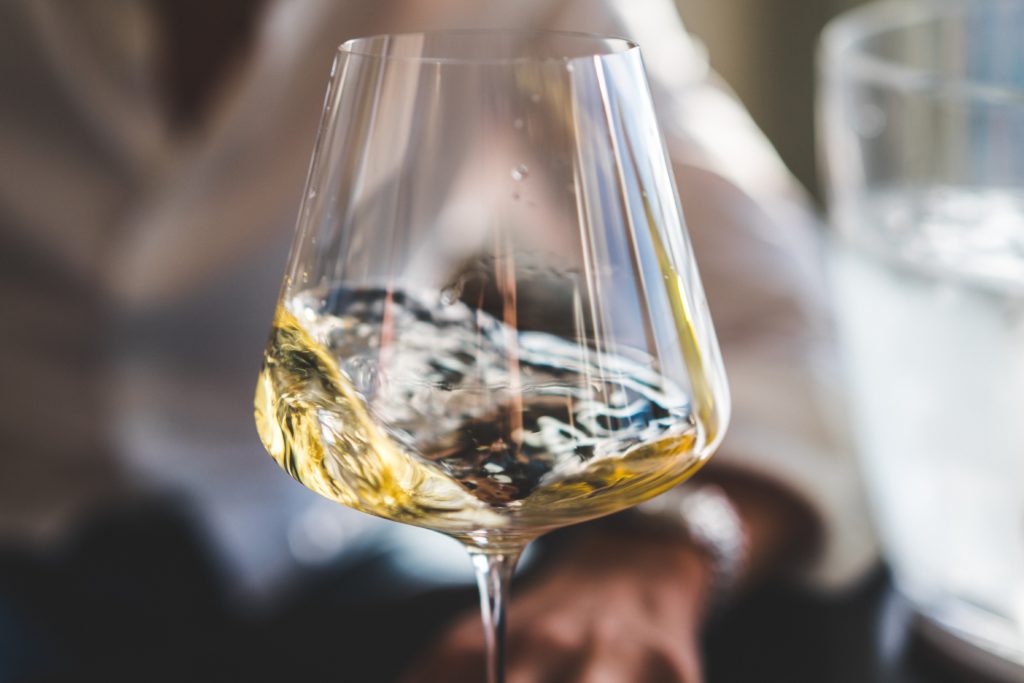 white wine swirling in a wine glass