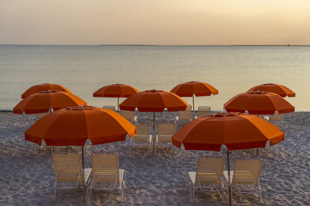 Lounge chairs and umbrellas on the beach at Sea Crest Beach Hotel in North Falmouth