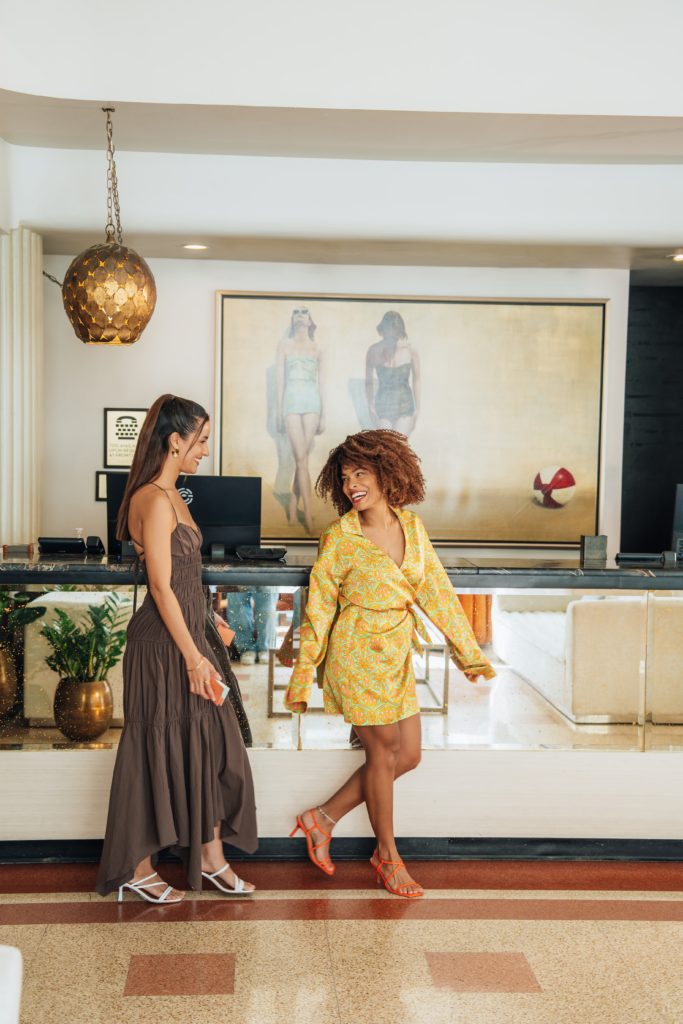 Two young women walking through lobby of Winter Haven Hotel in Miami Beach