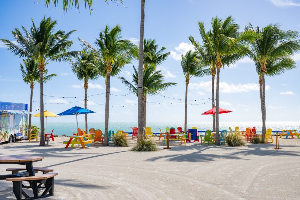 Food truck and colorful picnic tables by the ocean at Islander Resort in Islamorada
