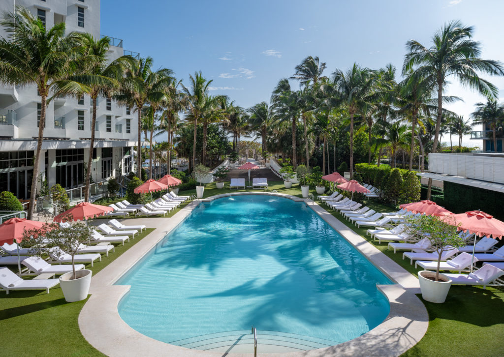 Outdoor pool surrounded by lounge chairs at Cadillac Hotel & Beach Club in Miami Beach