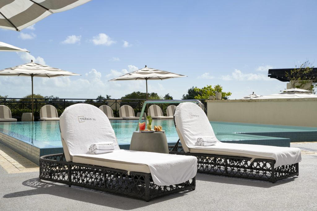 Lounge chairs by the outdoor pool at THesis Hotel Miami